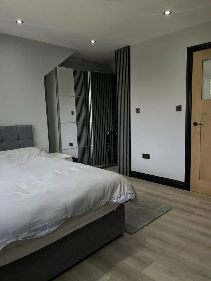 Grey bedroom with mirrored wardrobe and fresh bedding