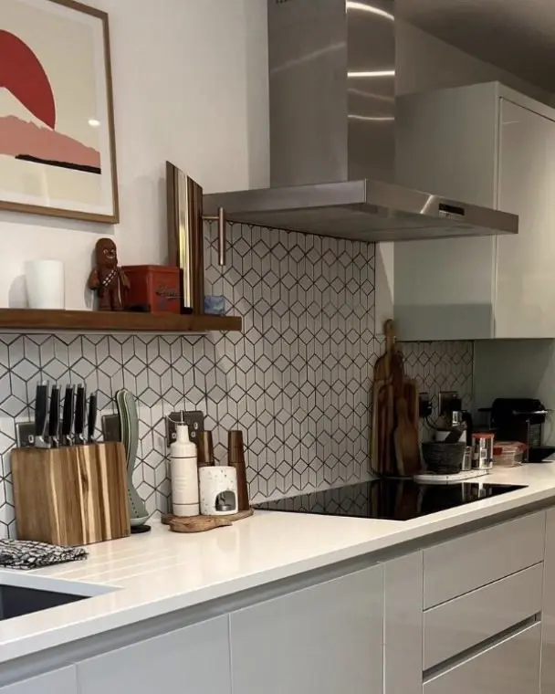 Modern kitchen with tiled splashback and white worktops