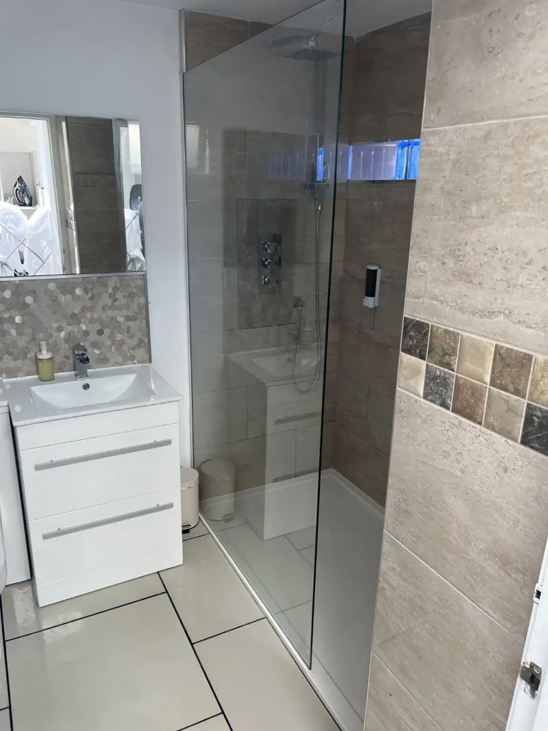 Walk-in shower room with polished glass and tiles